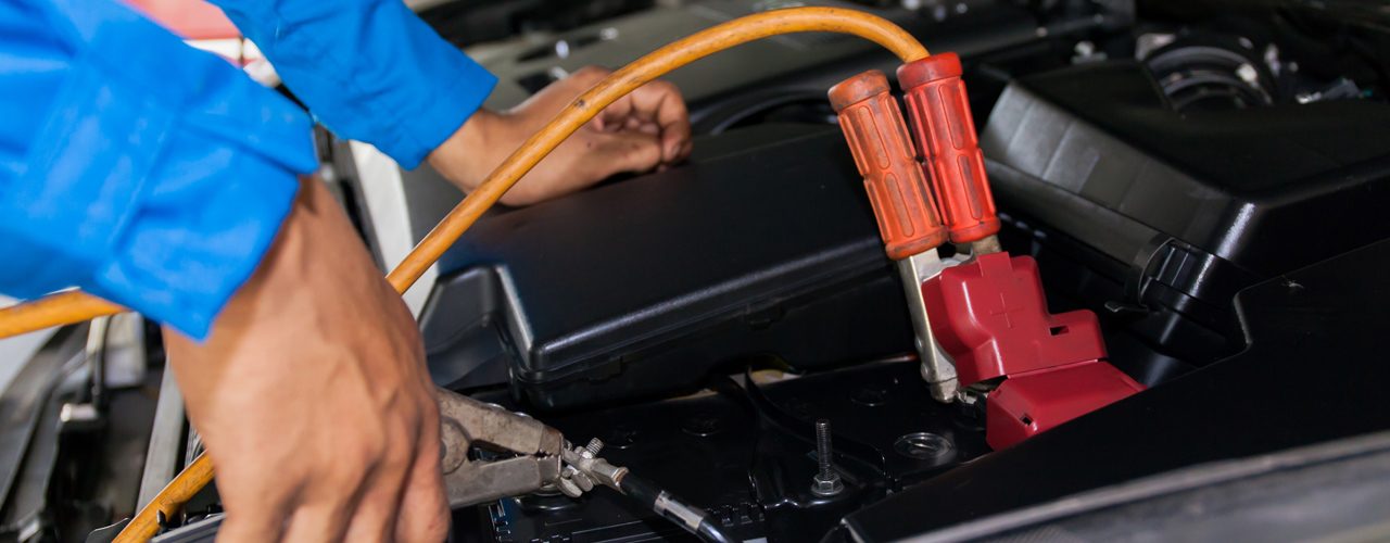 Technician-Performing-Car Jump Start Service On Battery