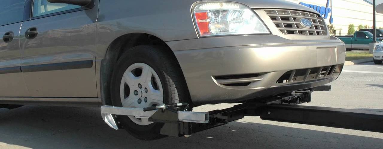 Wheel Lift Tow Truck Towing An SUV