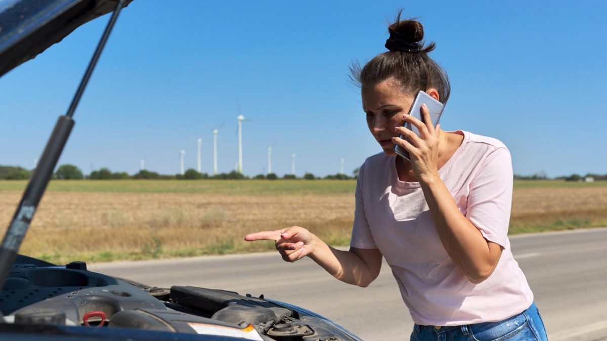 woman with a broken down car