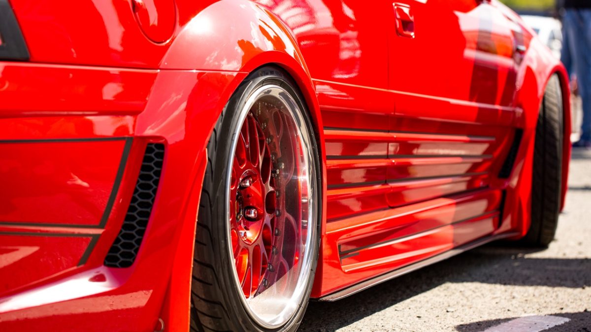 Red sports tuned car rear view of the wheel, close-up .