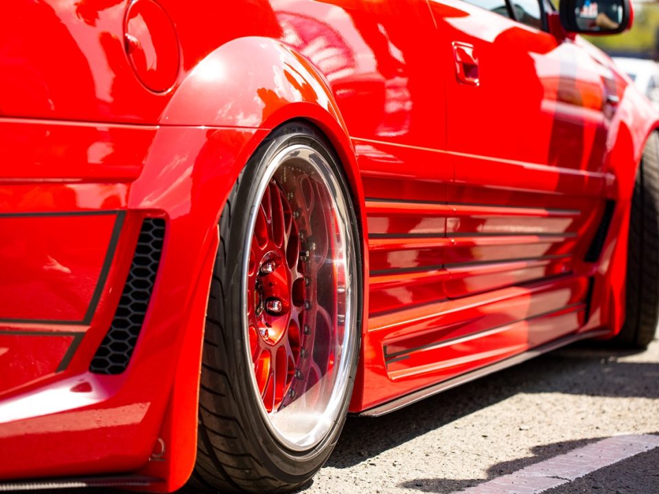 Red sports tuned car rear view of the wheel, close-up .