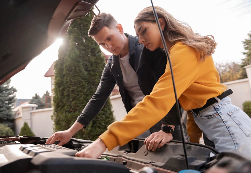 couple with a car that won't start after an accident