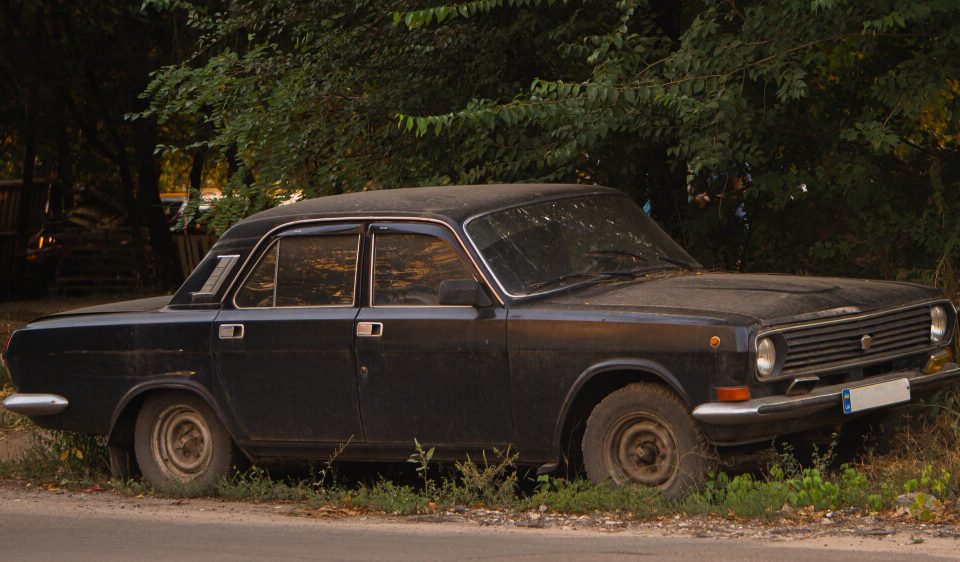 old junk car on the side of the road